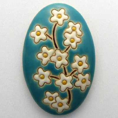 domed oval cabochon with blooming tree