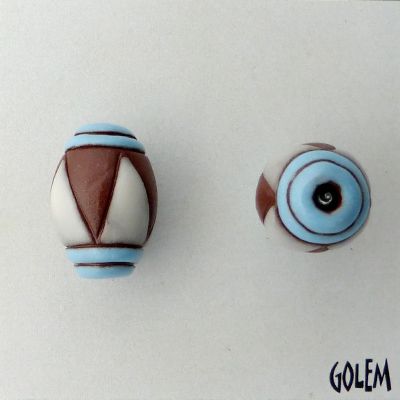 Oval bead, white triangles, red clay