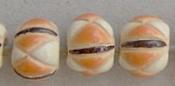 White, orange & black on round bead