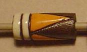 white lines, yellow triangles on dark tube bead