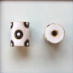 Black circles on white tube