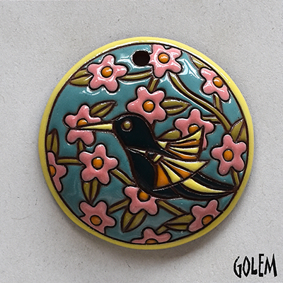 round pendant with humingbird