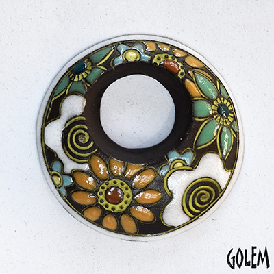 off-center donut pendant with flowers, dark clay