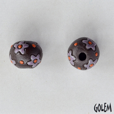 purple flowers on dark clay round bead