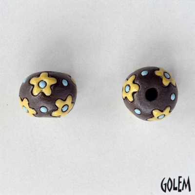 yellow flowers on dark clay round bead