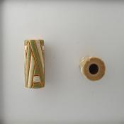 green & white design on off white tube -