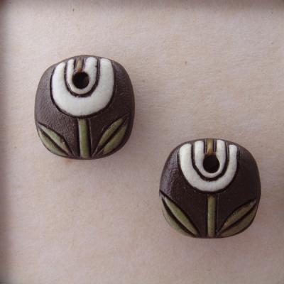 White tulips on dark clay