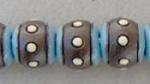 White dots, dark round bead