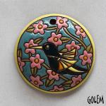 round pendant with humingbird