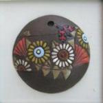 round pendant, flowers on dark backgroun