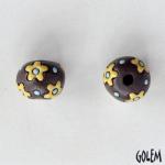yellow flowers on dark clay round bead