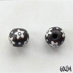 White flowers, blue dots on dark clay