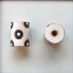 Black circles on white tube