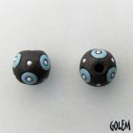 Blue circles on dark clay, round bead