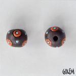 Orange circles on dark clay, round bead