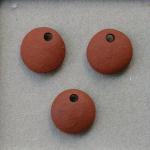 Unglazed pair of charms, terracotta