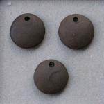 Unglazed pair of charms, dark clay