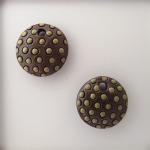 Light green polka dots on dark clay charm